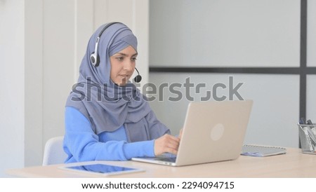 Muslim Woman in Hijab with Headset Talking with Customers Online in Call Center