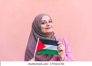 Muslim Woman In Hijab Holds Flag Of Palestine