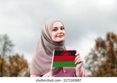 Muslim Woman In Hijab Holds Flag Of Malawi