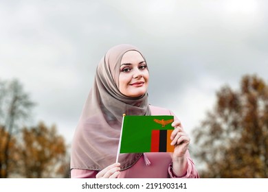 Muslim Woman In Hijab Holds Flag Of Zambia