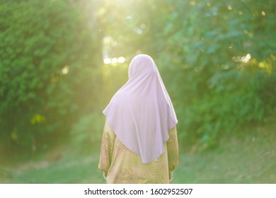 Muslim Woman Looking At The  Back At A Park