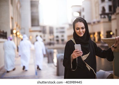 Muslim Woman Messaging On Her Mobile Phone.