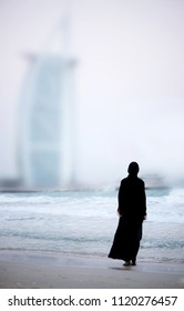 Muslim woman on the beach in Dubai