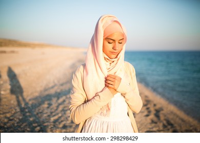 Muslim Woman On The Beach Spiritual Portrait.Humble Muslim Woman Praying On The Beach.Summer Holiday,muslim Woman Walking On The Beach