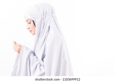 Muslim woman in prayer garb, praying. white background, isolated, negative space, high key - Shutterstock ID 1103699912