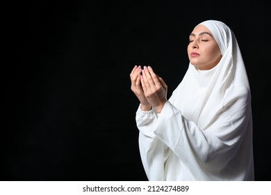 Muslim Woman Praying On Dark Background