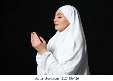 Muslim Woman Praying On Dark Background