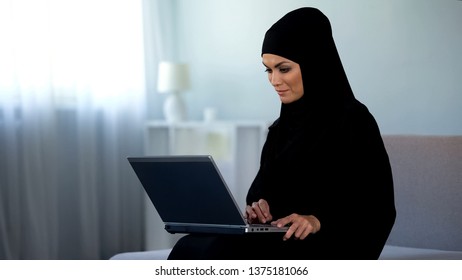 Muslim Woman Scrolling Laptop, Working At Home, Online Education, Technology