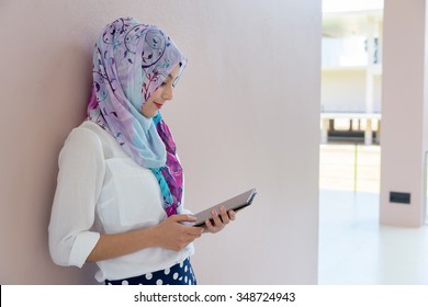 Muslim Woman Standing , Holding Tablet Computer