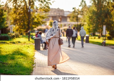 Muslim Woman Walking In The Park. View From The Back.