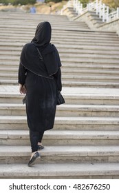 Muslim Woman Walking Up Stairs On Outdoor, Back View