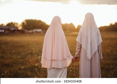 A Muslim Woman Walks In The Open Air. The View From The Back