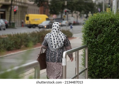 A Muslim Woman Wearing A Headscarf, Religious Dress And Symbol