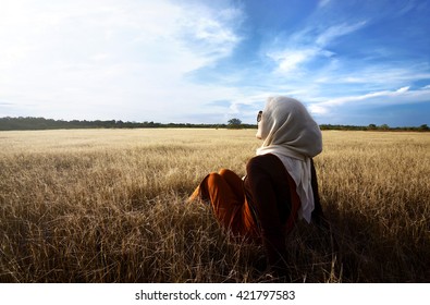 Muslim woman wearing hijab relaxing on savanna at sumba island indonesia