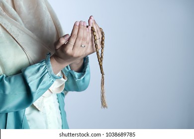 A Muslim Woman Wearing Moslem Clothes With Hijab And Rosary, Praying In The Mosque, Muslim Woman Raising Hand Pray