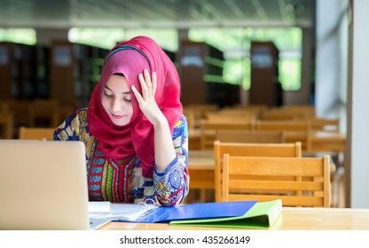 Muslim Woman Working With Computer In Library.