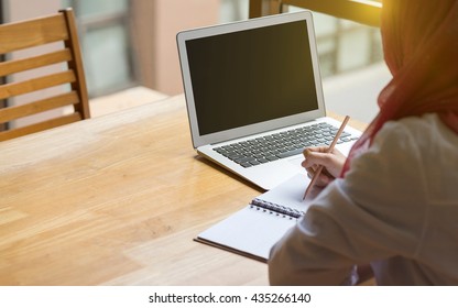 Muslim Woman Working With Computer In The Room , Writing Paper