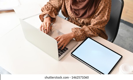 Muslim Woman Working With Laptop Computer On Work Table And Close Up Top View Shot.