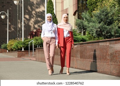 Muslim women in hijabs outdoors on sunny day - Powered by Shutterstock