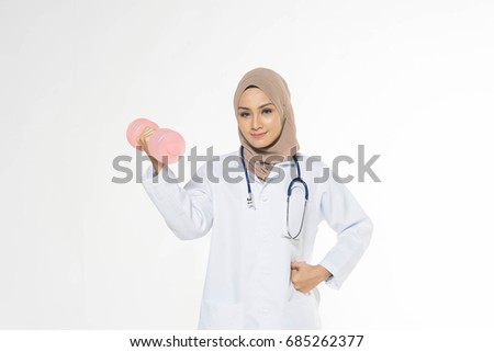 Muslim women medical doctor with dumbbell. Educational concept.