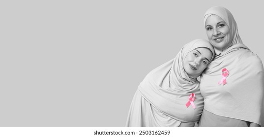 Muslim women with pink ribbons on light background with space for text. Breast cancer awareness concept - Powered by Shutterstock