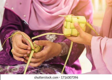Muslim women weaving ketupat during raya celebration