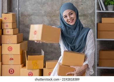 Muslim Young Asian Business Woman Startup Sme Small Business Entrepreneur SME Distribution Warehouse With Parcel Mail Box. Muslim Girl SME Online Marketing And Product Packaging And Delivery Service.