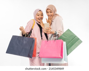 Muslim Young Friend Using Smart Phone And Holding Shopping Bag