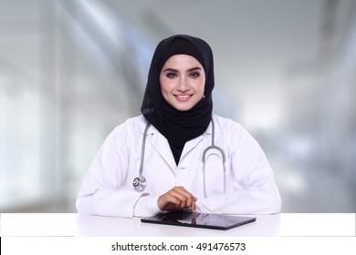  Muslimah Doctor Holding A Stethoscope With Ipad  Isolatedon Blur Background 