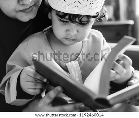 Similar – grandma reading a book to a child