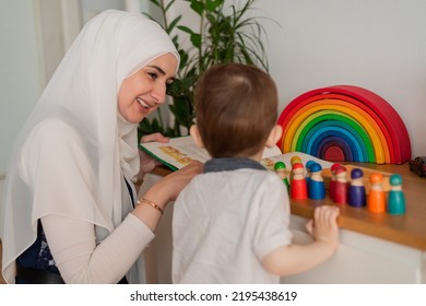 A Musllim teacher and preschool child playing together with colorful toys in the Montessori school classroom or kindergarten. - Shutterstock ID 2195438619