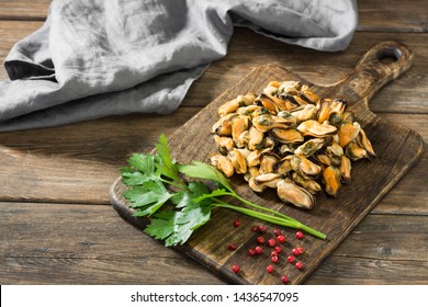 Mussel Meat On A Wooden Board On A Wooden Table. Rustic Style