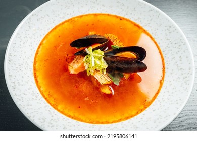 Mussel And Salmon Stew. Chef Pouring Hot Sea Food Broth