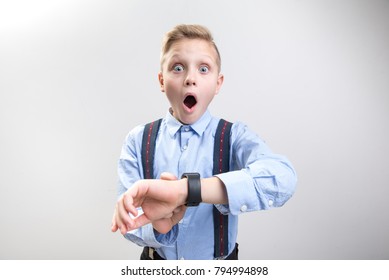 I must hurry. Waist up portrait of boy businessman being late for a conference. He is looking at camera with great wonderment. Isolated on background