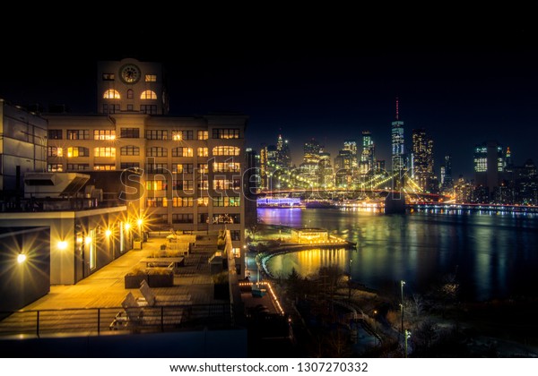 Must see when visiting New York City. View of
Lower Manhattan and  Brooklyn at sunset. Night scene. Light trails.
City lights. Urban living, travel, real estate  and transportation
concept