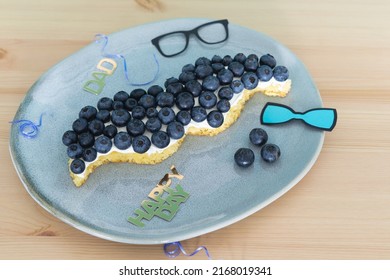 Mustache Shaped Cake With Blueberries And Decoration On Wooden Background. Copy Space. Father's Day. Masculine Concept.