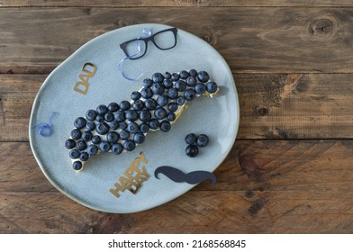 Mustache Shaped Cake With Blueberries And Decoration On Wooden Background. Copy Space. Father's Day. Masculine Concept.