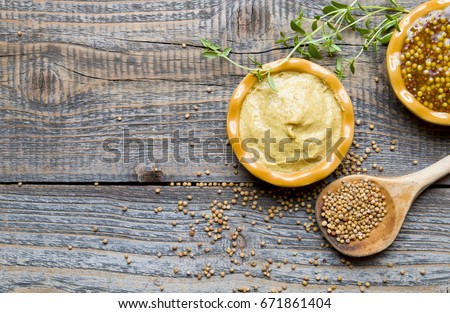 Mustard on wood with mustard seeds