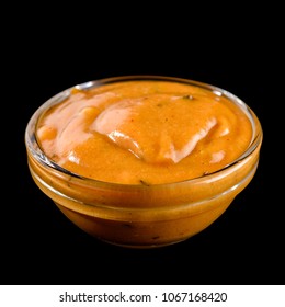 Mustard Sauce In A Glass Bowl Isolated On Black Background