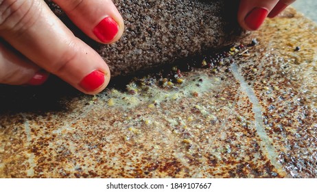 Mustard Seeds And Cumin Near Fingers Of A Woman Holding A Stone