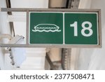 muster station lifeboat sign on a merchant ship cruise liner  isolated