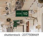 muster station point sign and landing tender emergency dingy location signs on board a cruise merchant ship