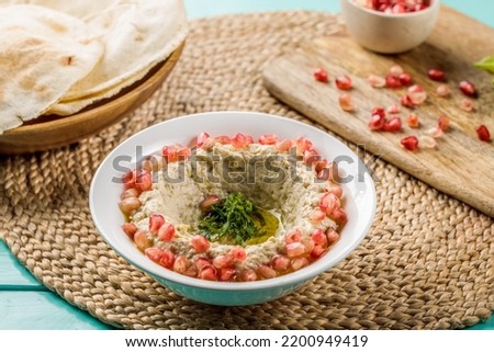 Mutable with pita bread served in dish isolated on wooden table side view of middle eastern food