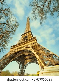 A muted colour view of the Eiffel Tower in Paris, France, as seen from underneath