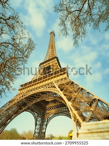 A muted colour view of the Eiffel Tower in Paris, France, as seen from underneath