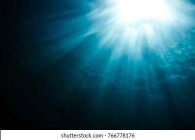 Muted Rays of Sunlight Through Deep Ocean Water