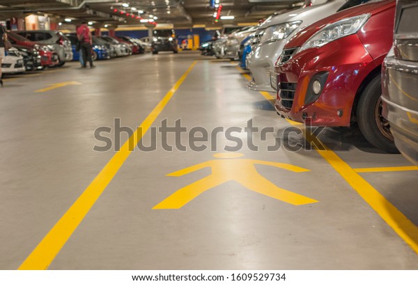 Mutiara Damansara,\
Kuala Lumpur, Malaysia - January 02, 2020 : Pedestrian walk in\
yellow marking in all car parks designed for safety reason and\
parking provision\
compliance.