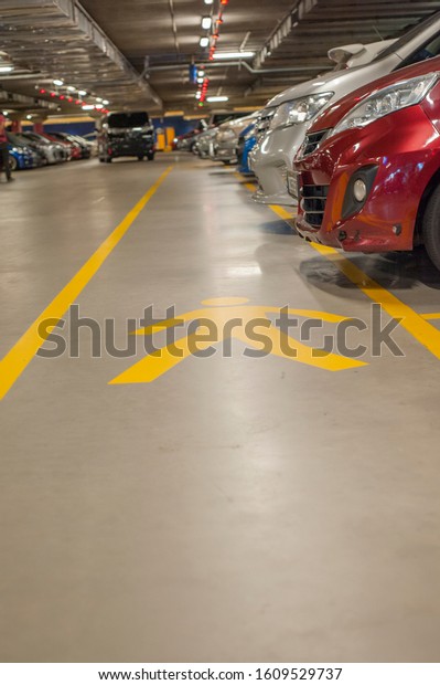 Mutiara Damansara,\
Kuala Lumpur, Malaysia - January 02, 2020 : Pedestrian walk in\
yellow marking in all car parks designed for safety reason and\
parking provision\
compliance.