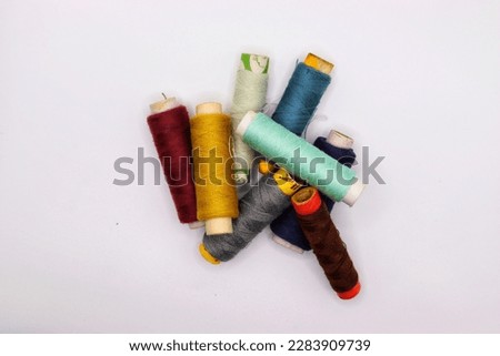 Muticolor sewing threads on white background