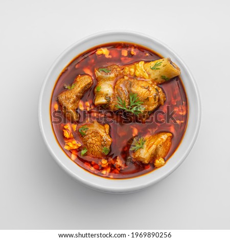 mutton curry or masala in a white bowl, top view, red spicy gravy